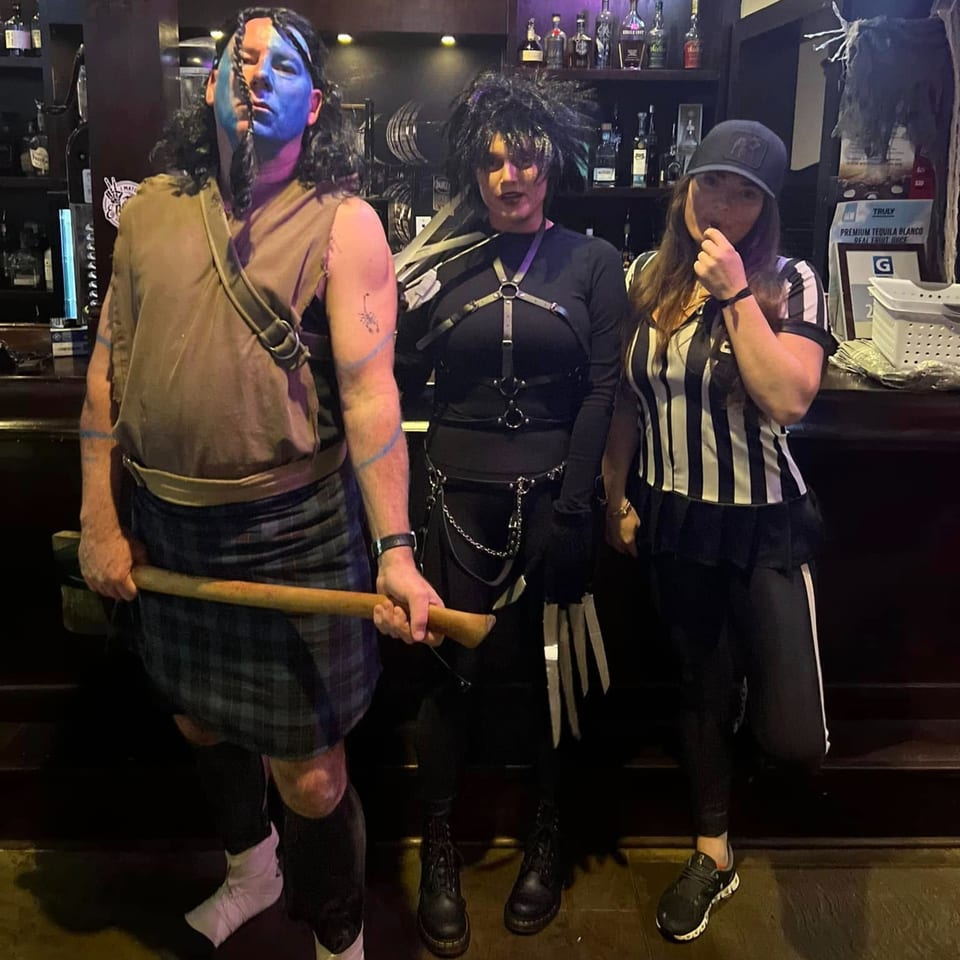 Three people in Halloween costumes, including Braveheart, Edward Scissorhands, and a referee, at The Tavern.